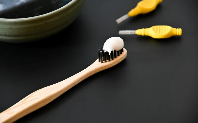 Oral hygiene tools including a tongue scraper and toothbrush for fighting bad breath