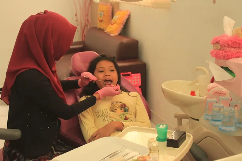 Young child smiling during a friendly dental checkup visit