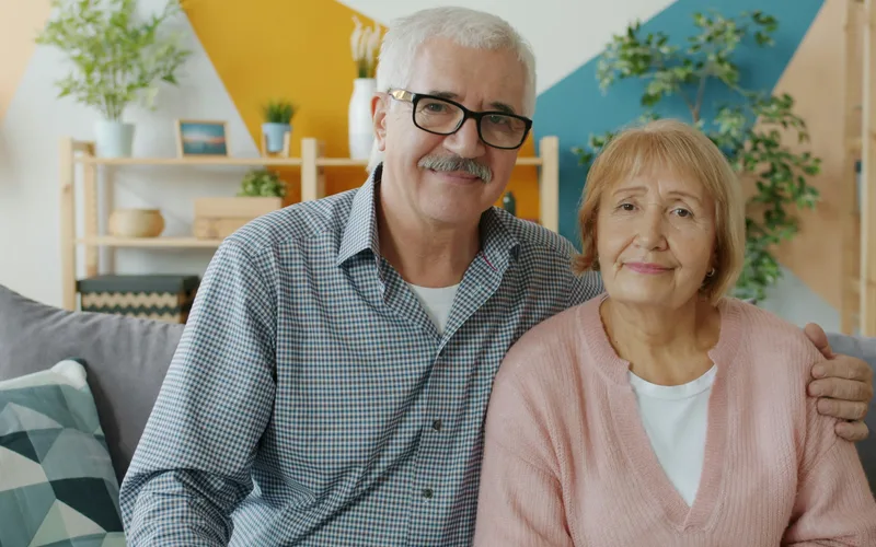 Senior couple enjoying a meal together, smiling comfortably while eating