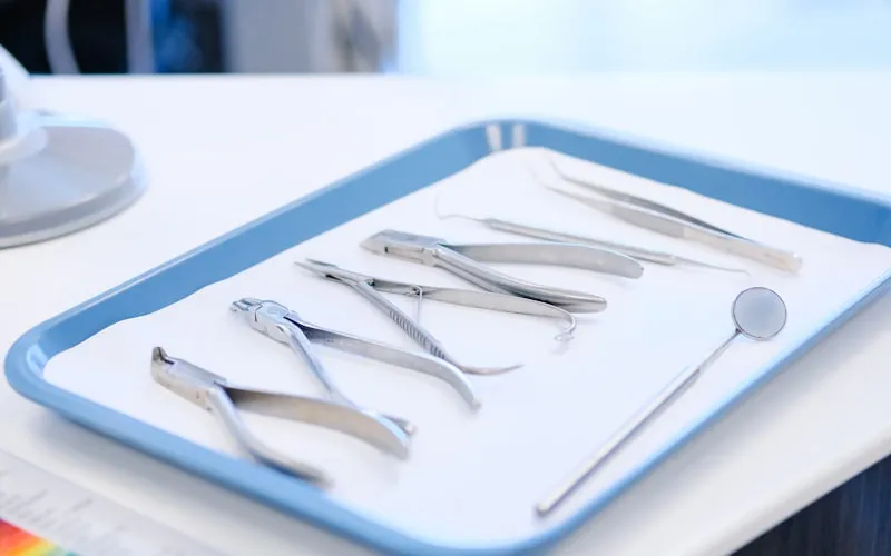 Clear dental aligner being held up showing the virtually invisible Invisalign design
