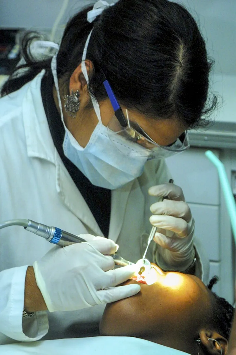 Dentist performing a root canal procedure on a patient in a modern dental office