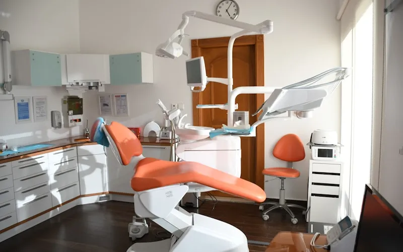 Dentist carefully placing a porcelain veneer on a prepared tooth