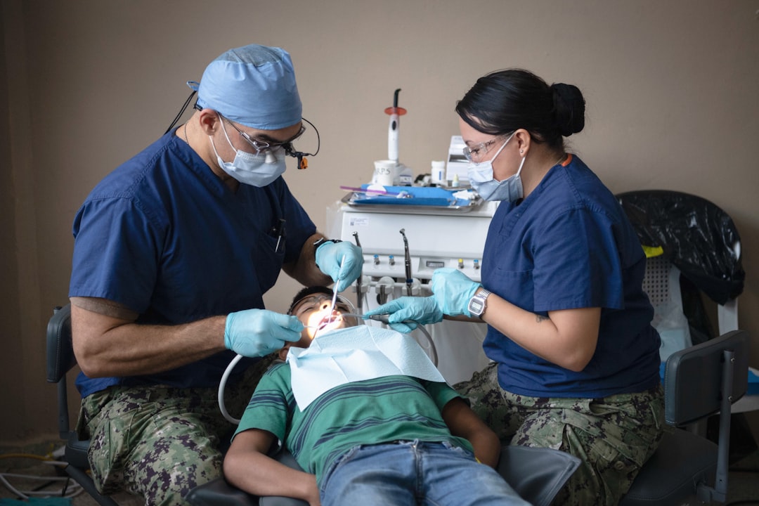 Dentists providing dental care to a patient