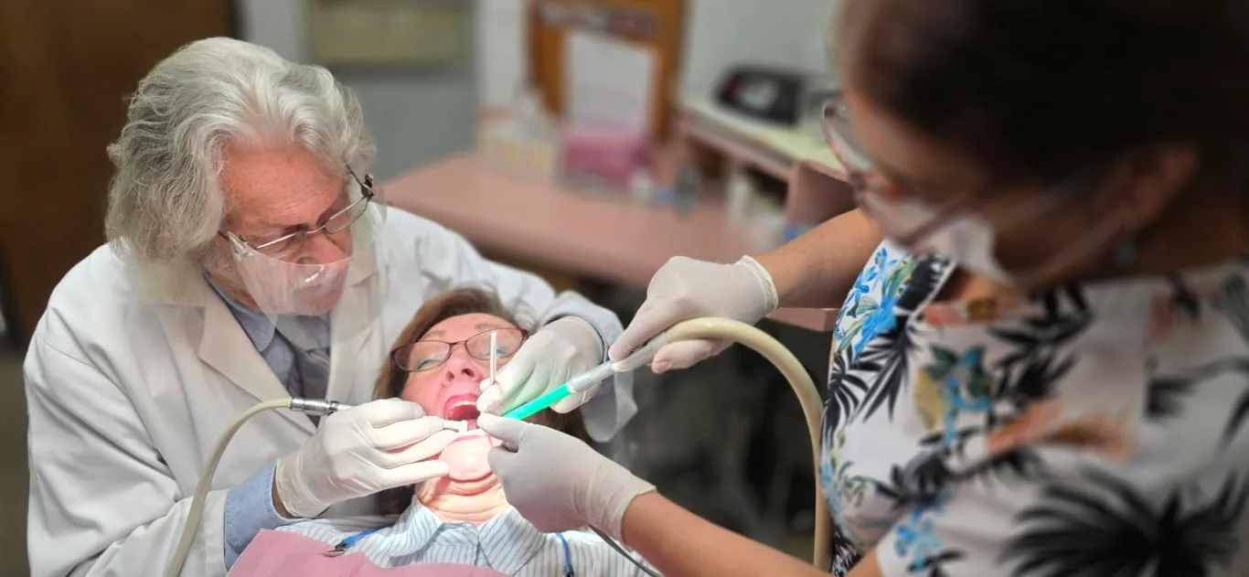Dr. Baldwin providing attentive dental care with his assistant