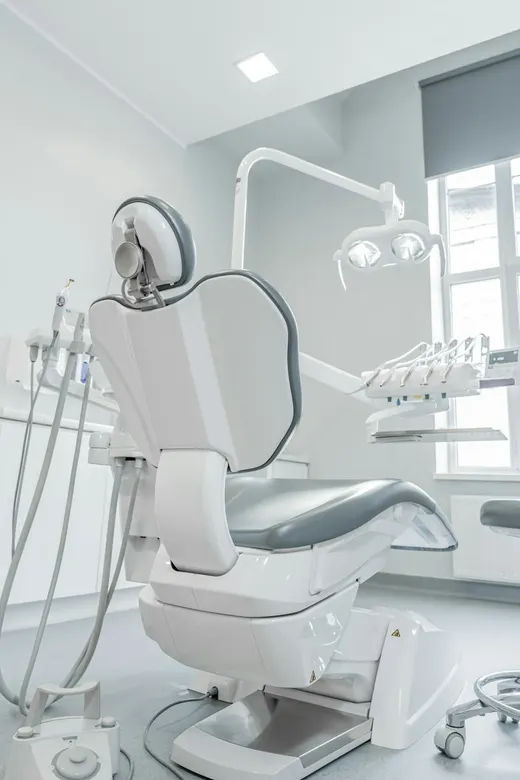 Clean dental treatment room with chair and equipment