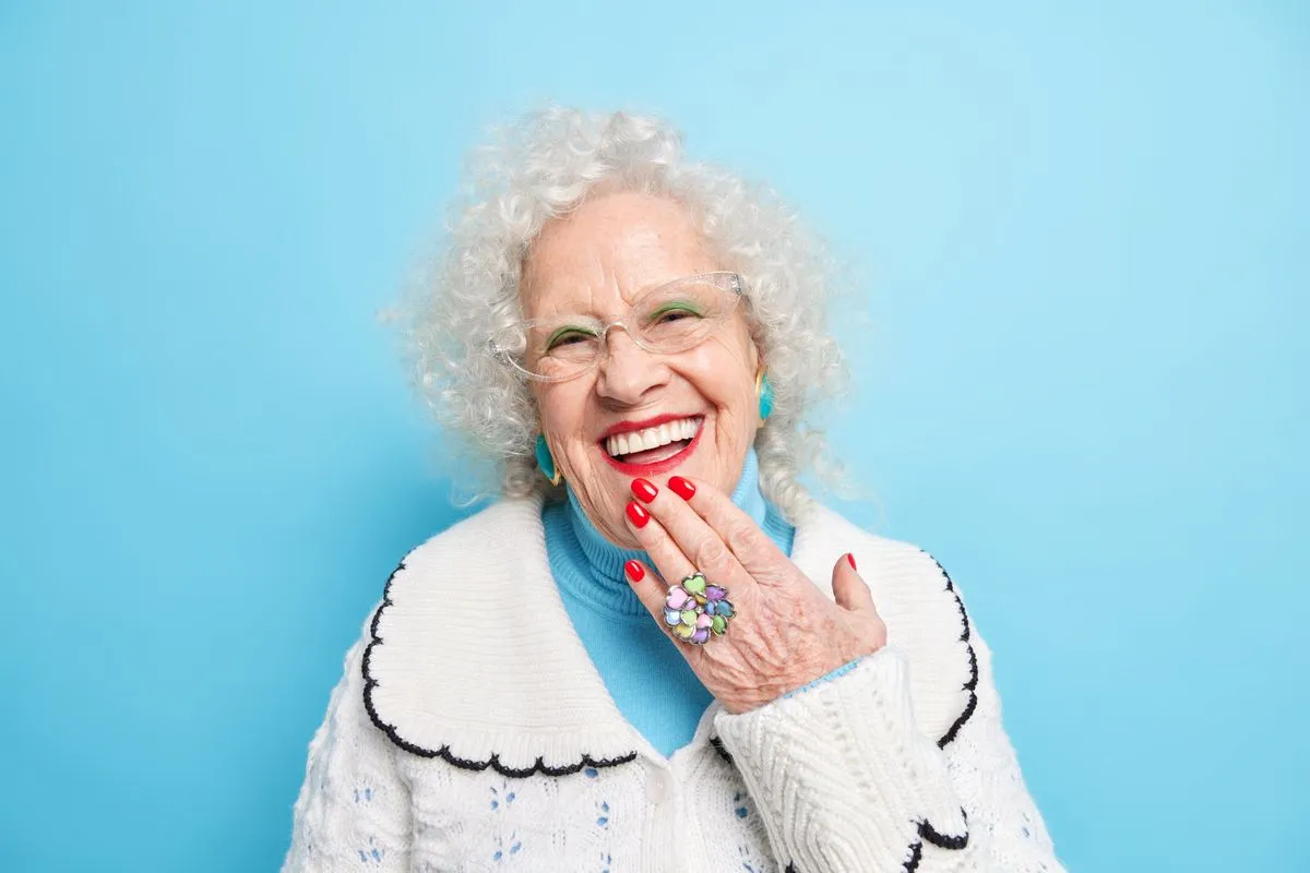 Senior patient smiling confidently with well-fitting dentures