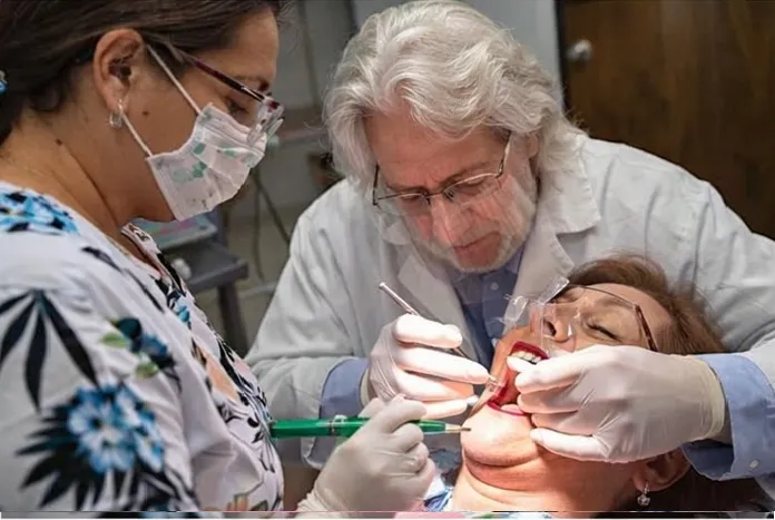 Dr. Baldwin and assistant working together on patient care